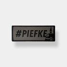 Spartanat Patch Klett mit dem Text Piefke und Pickelhaube in Tarn RAL 7013 und Schwarz