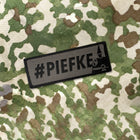 Spartanat Patch Klett mit dem Text Piefke und Pickelhaube in Tarn RAL 7013 und Schwarz