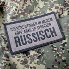 SPARTANAT Patch mit dem Text Ich höre Stimmen in meinem Kopf, aber sie sprechen russisch, mit Klett, in den Farben Schwarz und RAL7013